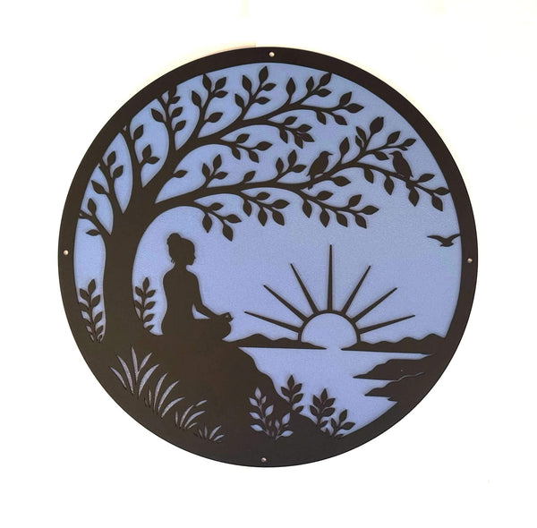Decorative wall art with a silhouette of a person meditating under a tree, with a sunset in the background.