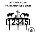 An address sign with a cowboy, cowgirl kneeling at a cross, with 2 horses behind them. 