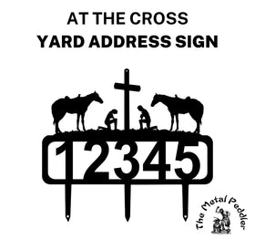 A cowboy and cowgirl kneeling "At the Cross" address sign featuring customizable numbers and three stakes at the bottom for easy lawn mounting.