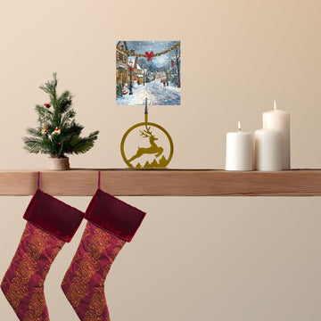 Christmas stockings on a shelf with a small tree, candles, and a reindeer ornament.