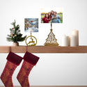 Christmas stockings hanging on a wooden shelf with decorative items and family photos.
