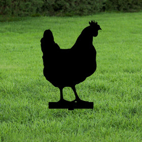 Black silhouette of a metal chicken on green grass