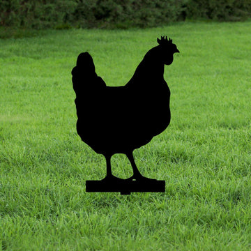 Black silhouette of a metal chicken on green grass