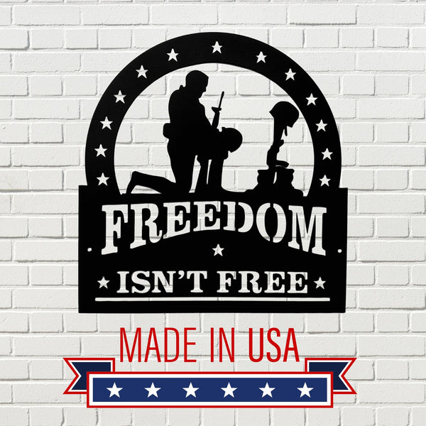 Decorative sign with 'Freedom Isn't Free' and 'Made in USA' text on a white brick background