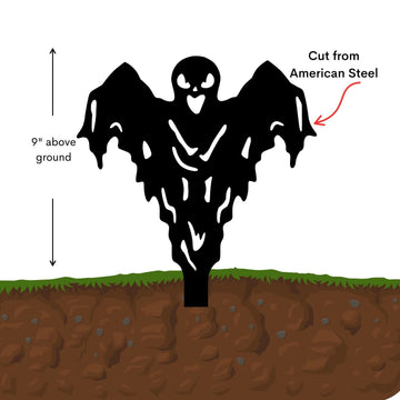 Black metal sculpture of a ghost figure above ground with text indicating height and material.