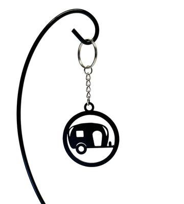 Metal camper-shaped keychain with detailed cutouts and a small chain link