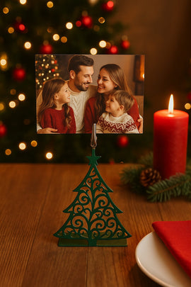 Family photo on a decorative Christmas tree stand with a candle and festive lights in the background