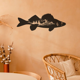 Black fish-shaped wall decal on a peach-colored wall with a wicker chair and decorative vase in the foreground.