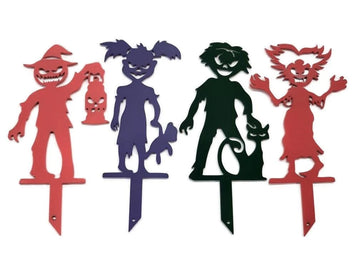 Set of colorful Halloween-themed metal yard stakes on a white background