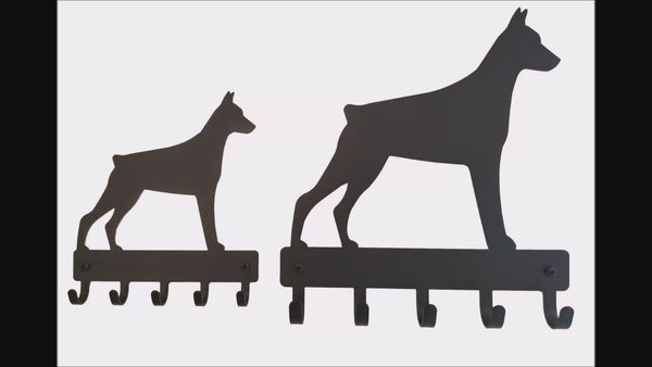 A short video compares the 2 different sizes of doberman key racks and leash hangers.
