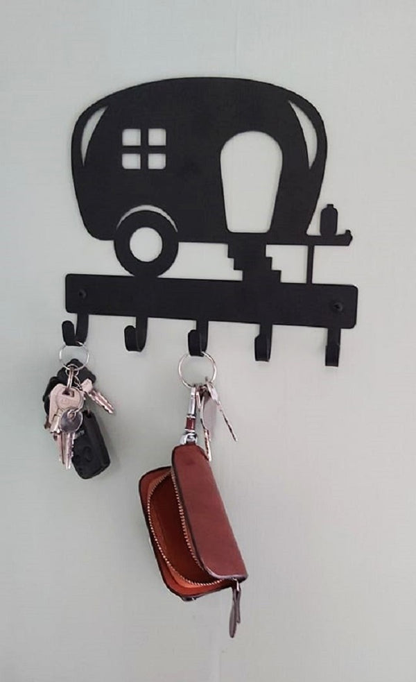 Camper Key Rack with 5 hooks and 2 sets of keys hanging from it.